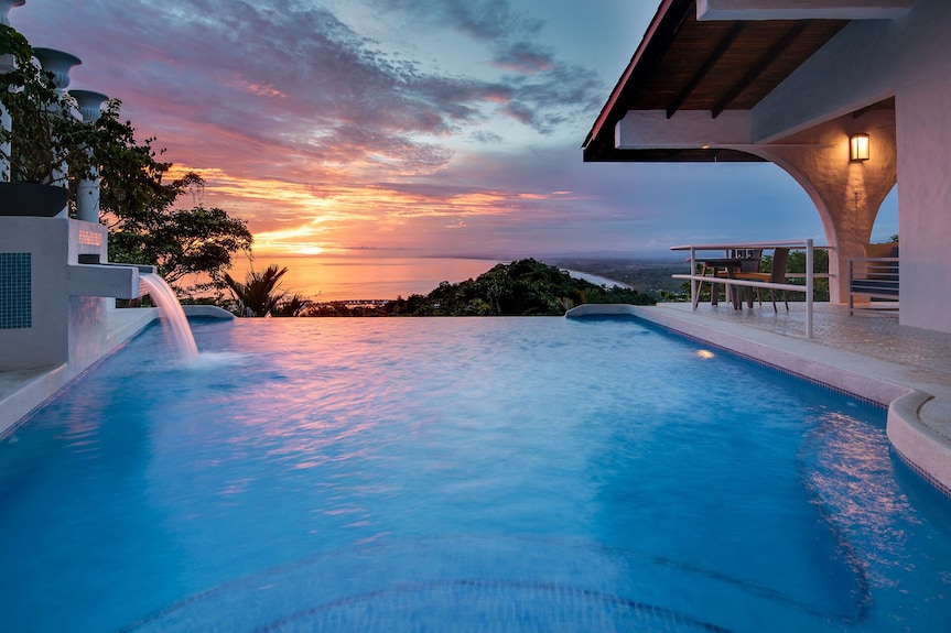 Luxury villa with infinity pool at sunset